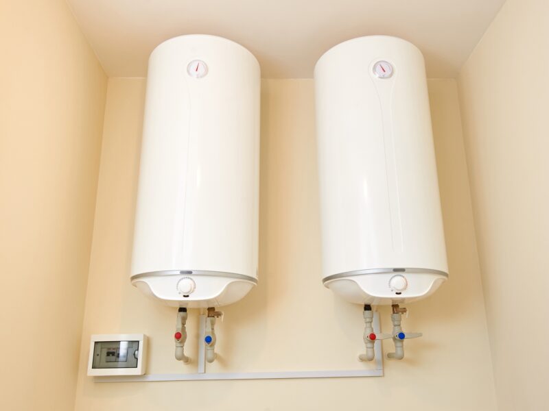 Two electric water heaters on the wall. Home wall mounted two water heating boilers.